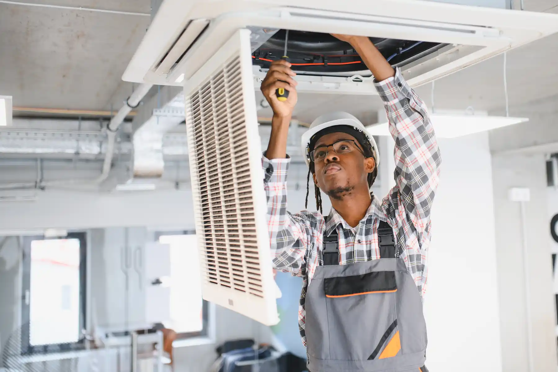 Team of technicians servicing commercial AC system in Dubai office building ensuring uninterrupted cooling for business operations and comfortable working environment for employees