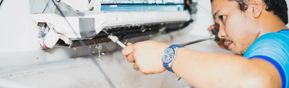 Certified technician performing scheduled AC maintenance under annual contract in Dubai providing preventive care and priority service for year-round cooling reliability