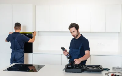 Skilled electrician installing energy-efficient ceiling fan with proper wiring and secure mounting in Dubai bedroom ensuring optimal air circulation and cooling