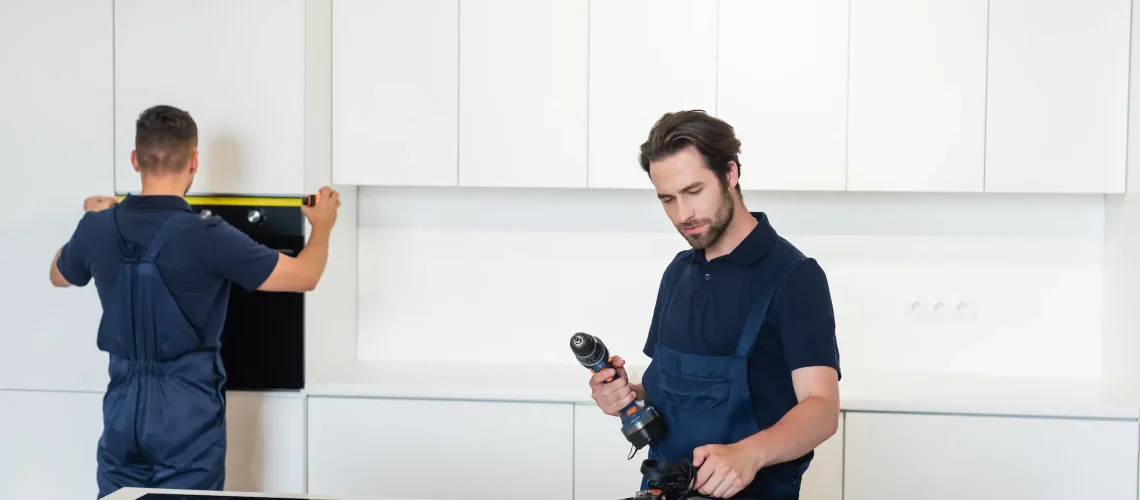 Skilled electrician installing energy-efficient ceiling fan with proper wiring and secure mounting in Dubai bedroom ensuring optimal air circulation and cooling