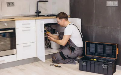 Professional plumber using state-of-the-art electronic leak detection equipment to find hidden pipe leak in Dubai property walls without causing damage
