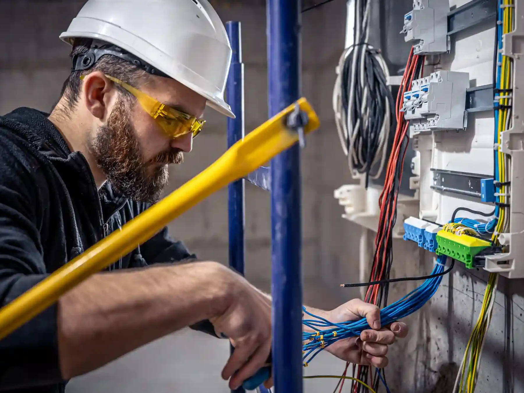 Expert electrician installing new power outlets and modern USB charging sockets in Dubai apartment wall for convenient device charging and connectivity